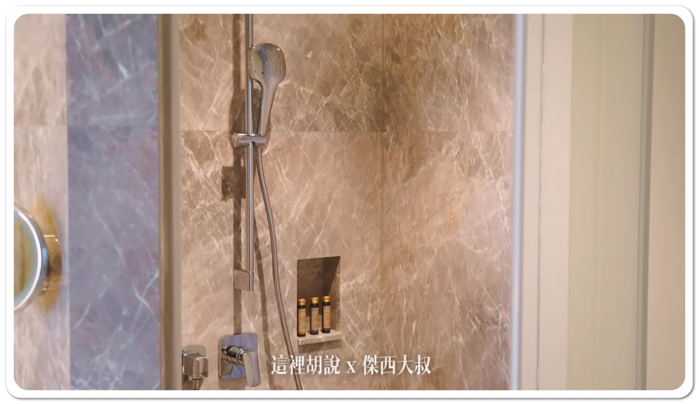 The toilet's an INAX brand.There's a handheld showerhead in addition to the regular one.
