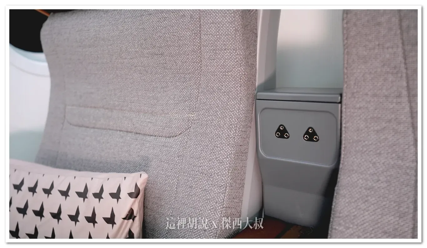 The headphones plug is located between seats and close to ear height.