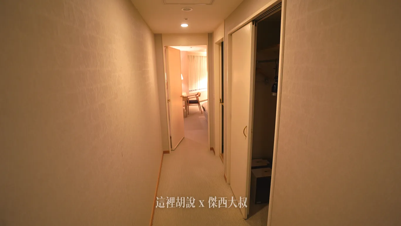 Walking towards the master bedroom from another corridor, there is a closet and a powder room.