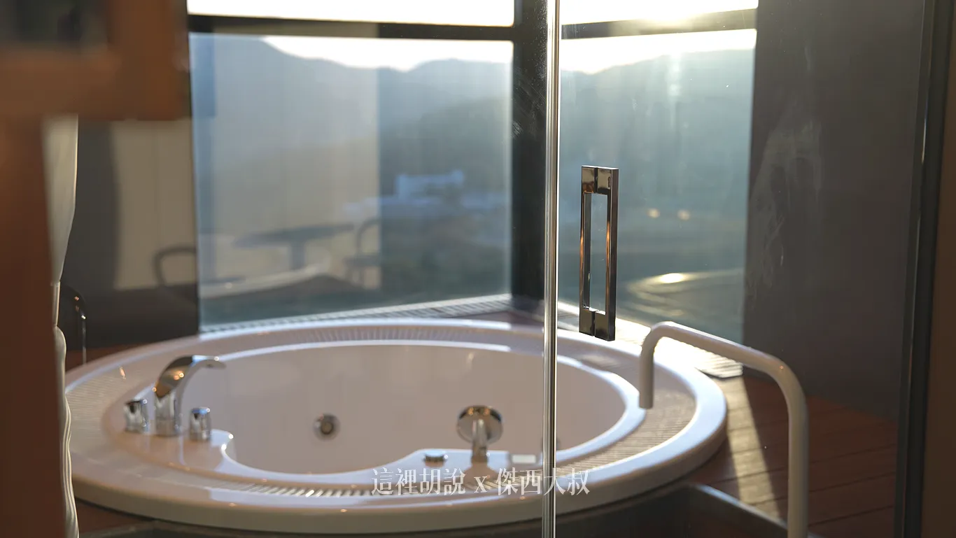 A glass door is used between the living room and the bathroom, maintaining an open view.