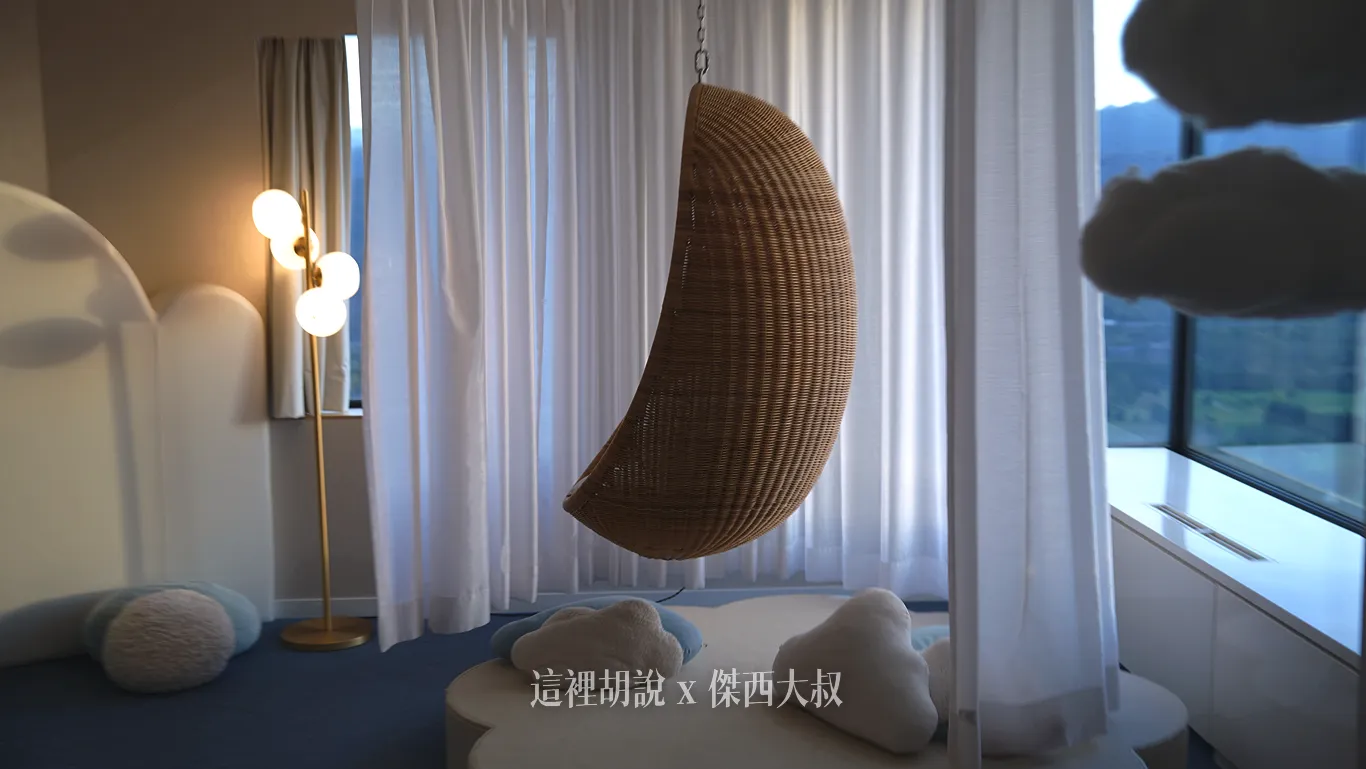 A rocking chair is placed in the prime viewing spot facing the window.