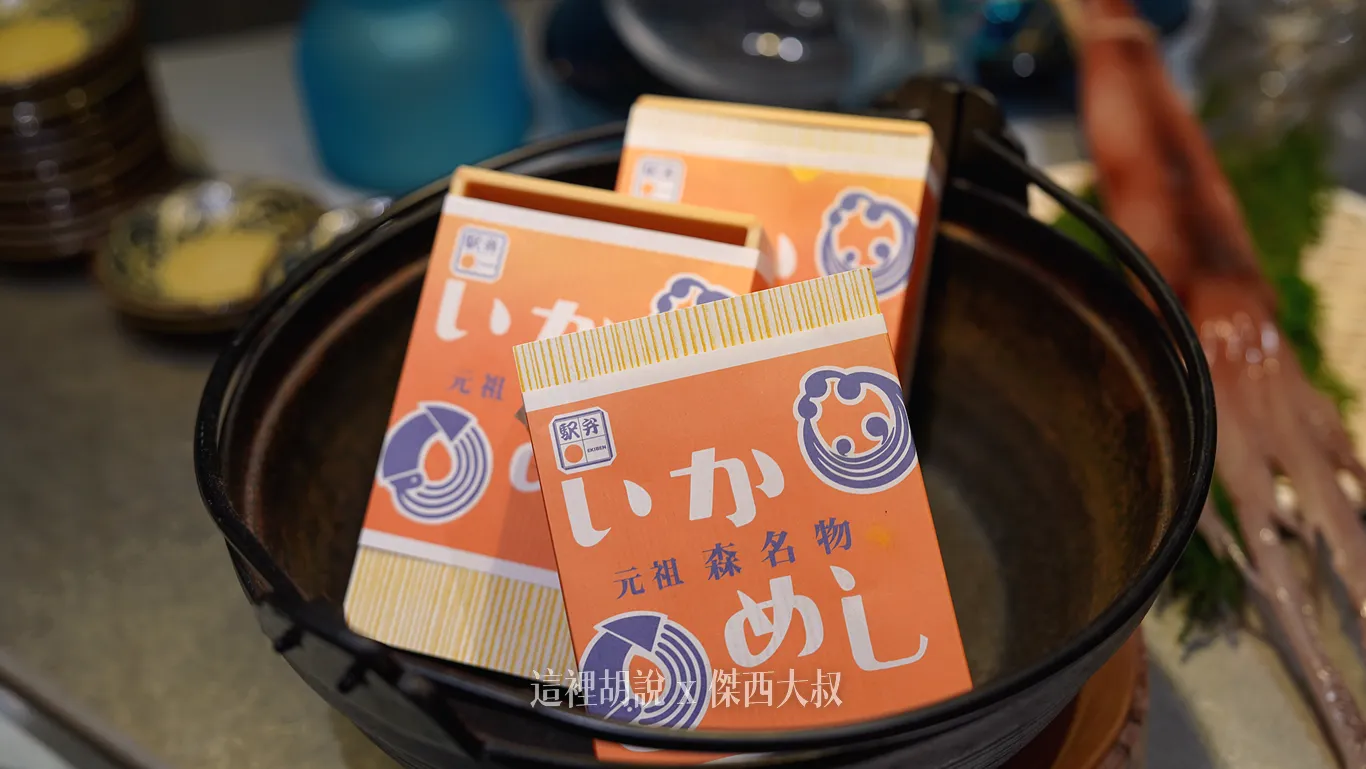 「烏賊飯」起源可以追溯到昭和16年（西元1941年），當時是為了滿足搭乘函館本線的旅客需求，而特別設計出的火車便當。在眾多美味的選擇中，阿部商店所製作的元祖「烏賊飯」，更是完整保留了當地手工製作的傳統烹調方式，將這份懷舊的滋味傳承至今。