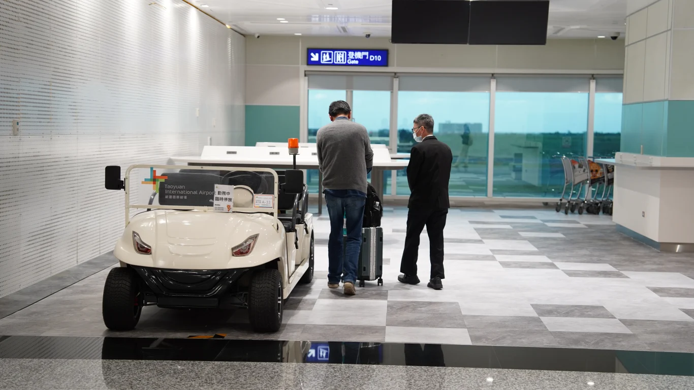 A passenger utilizing the care service cart to reach the North Concourse boarding gates.