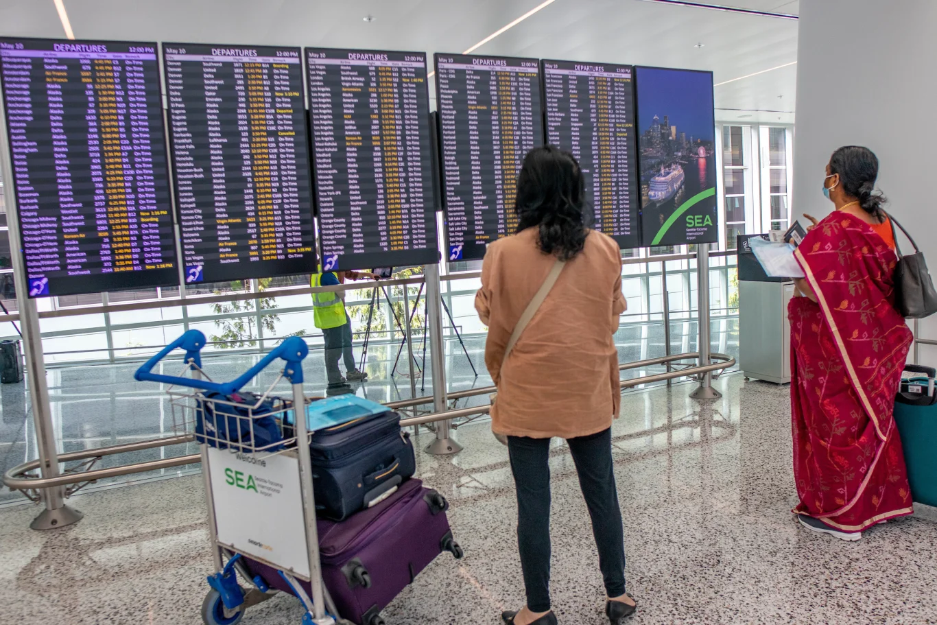 Flight status and gate display boards positioned at the transit junction.Photo / Port of Seattle