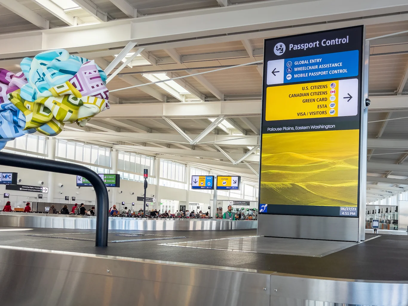 After collecting your bags, overhead signage directs you toward immigration lanes; most visa-waiver (ESTA) travelers will bear right. Photo / Port of Seattle